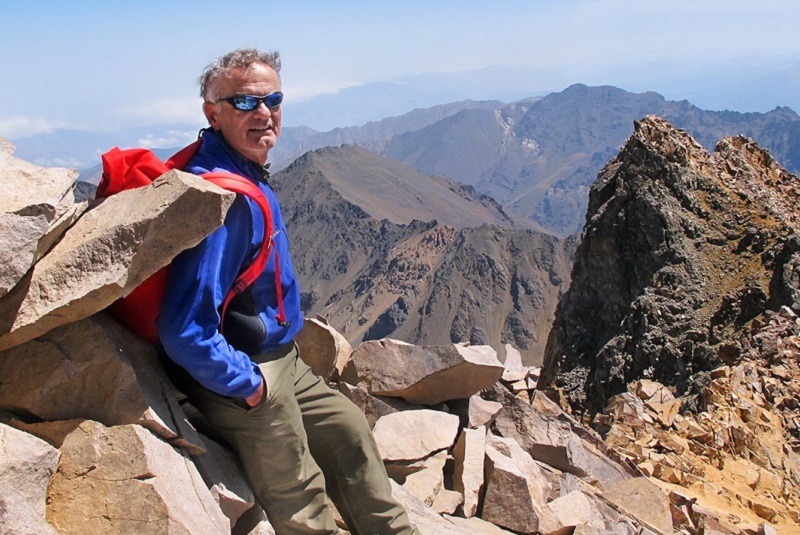 Award-winning travel specialist Vassi Koutsaftis on a mountain top with GeoEx