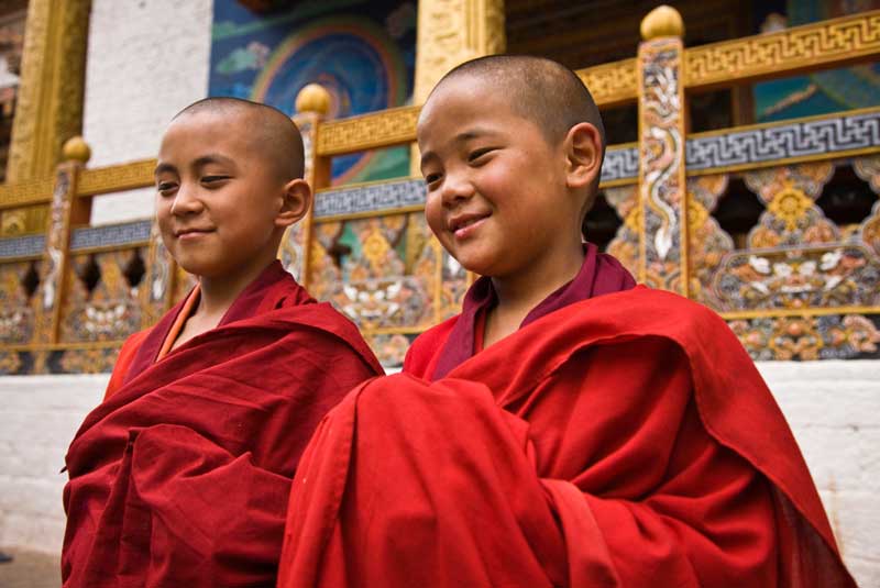 Young noviate monks pose at Punakha Dzong, Bhutan with GeoEx