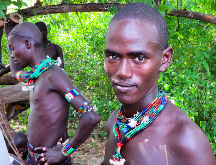 Hamar tribesmen get ready for the bull jump ceremony in the Omo Valley, Ethiopia with GeoEx.