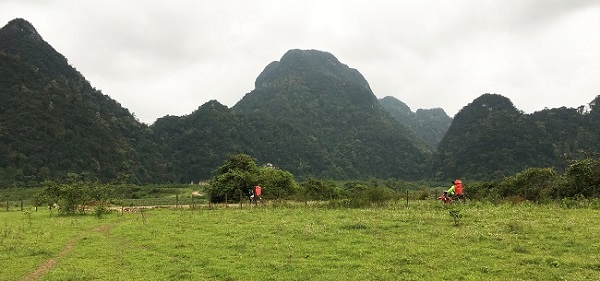 Porters carrying camping gear to cave camp in Phong Nha-Ke Bang National Park, central Vietnam | Adventure Travel with GeoEx