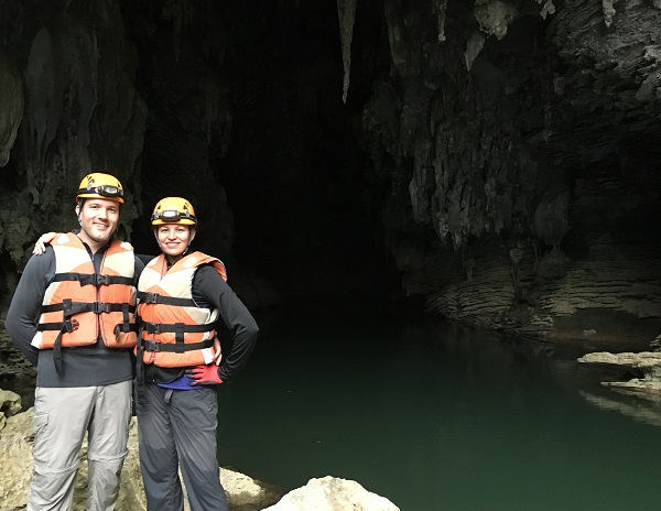 Standing triumphant after caving adventure | GeoEx Vietnam Travel