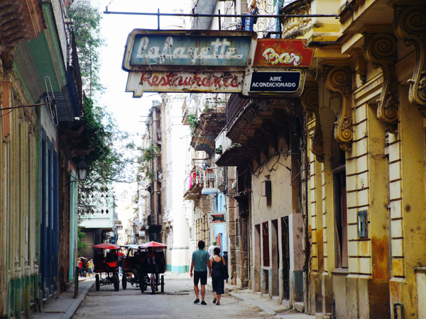 Couple walking down a Havana street with GeoEx