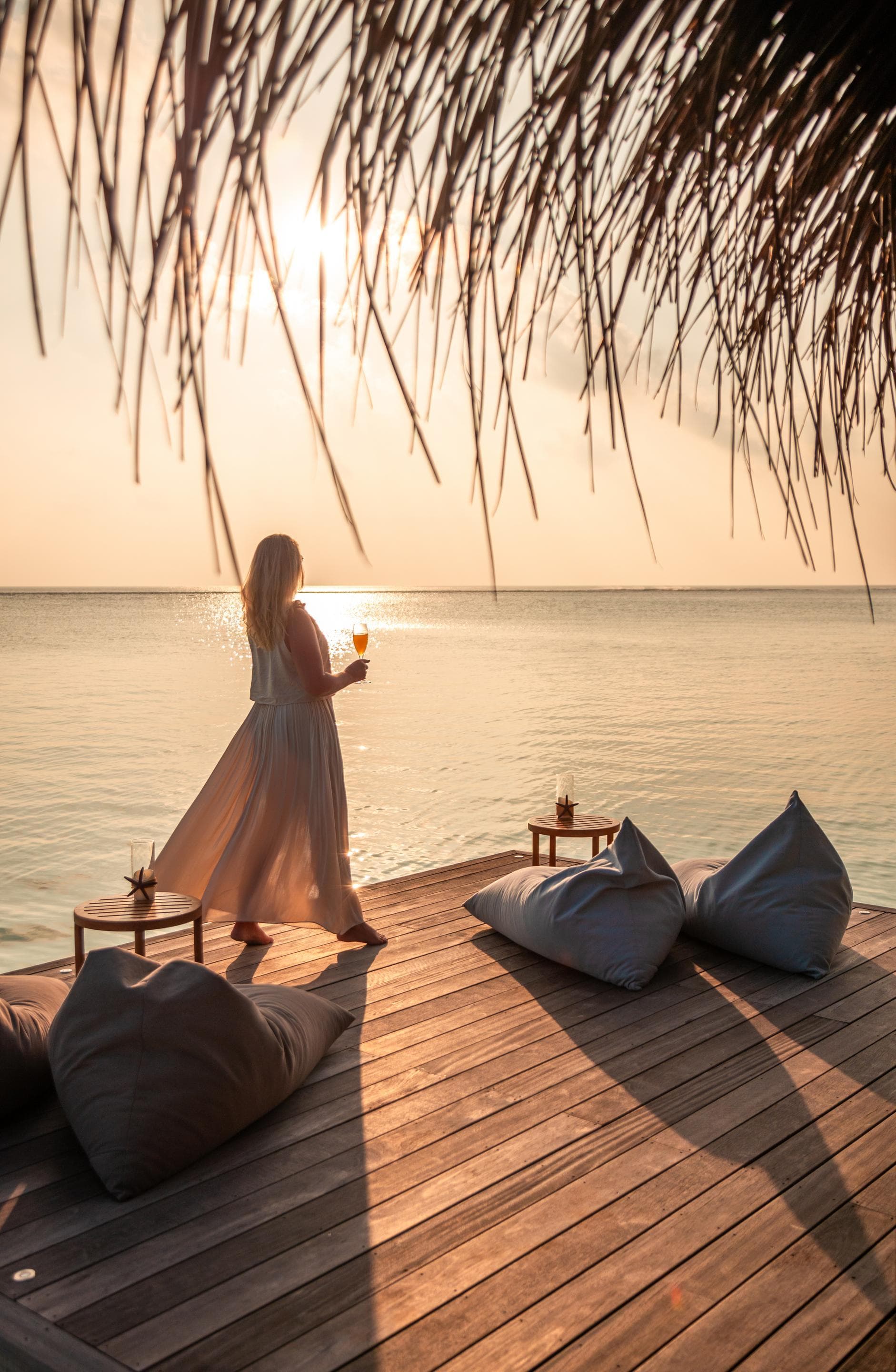 Woman admiring sunset from a pier