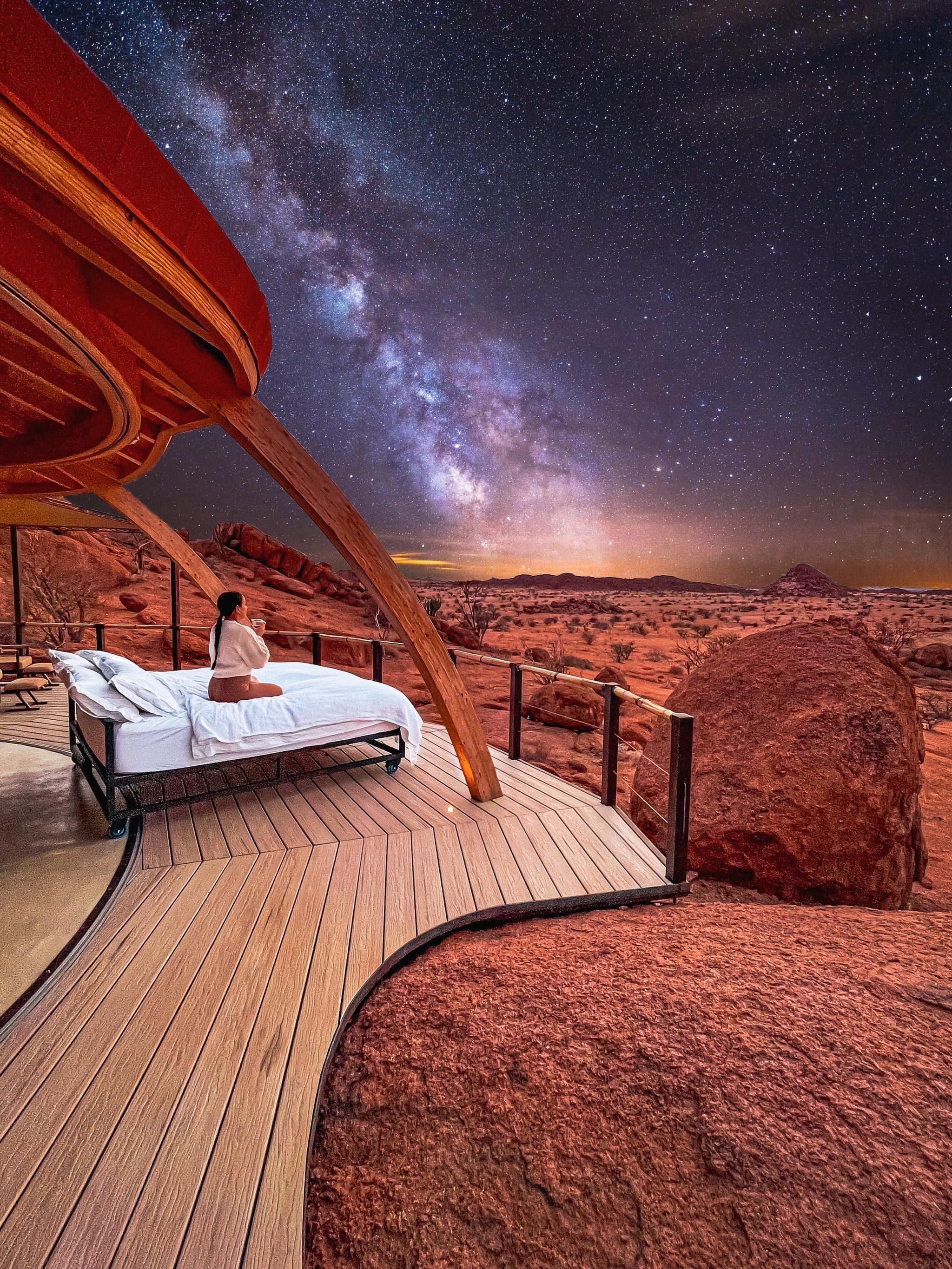 Woman in bed observing the desert and stars