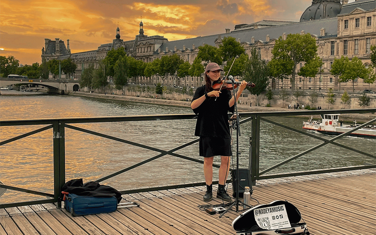 Violinist playing in Paris at sunset