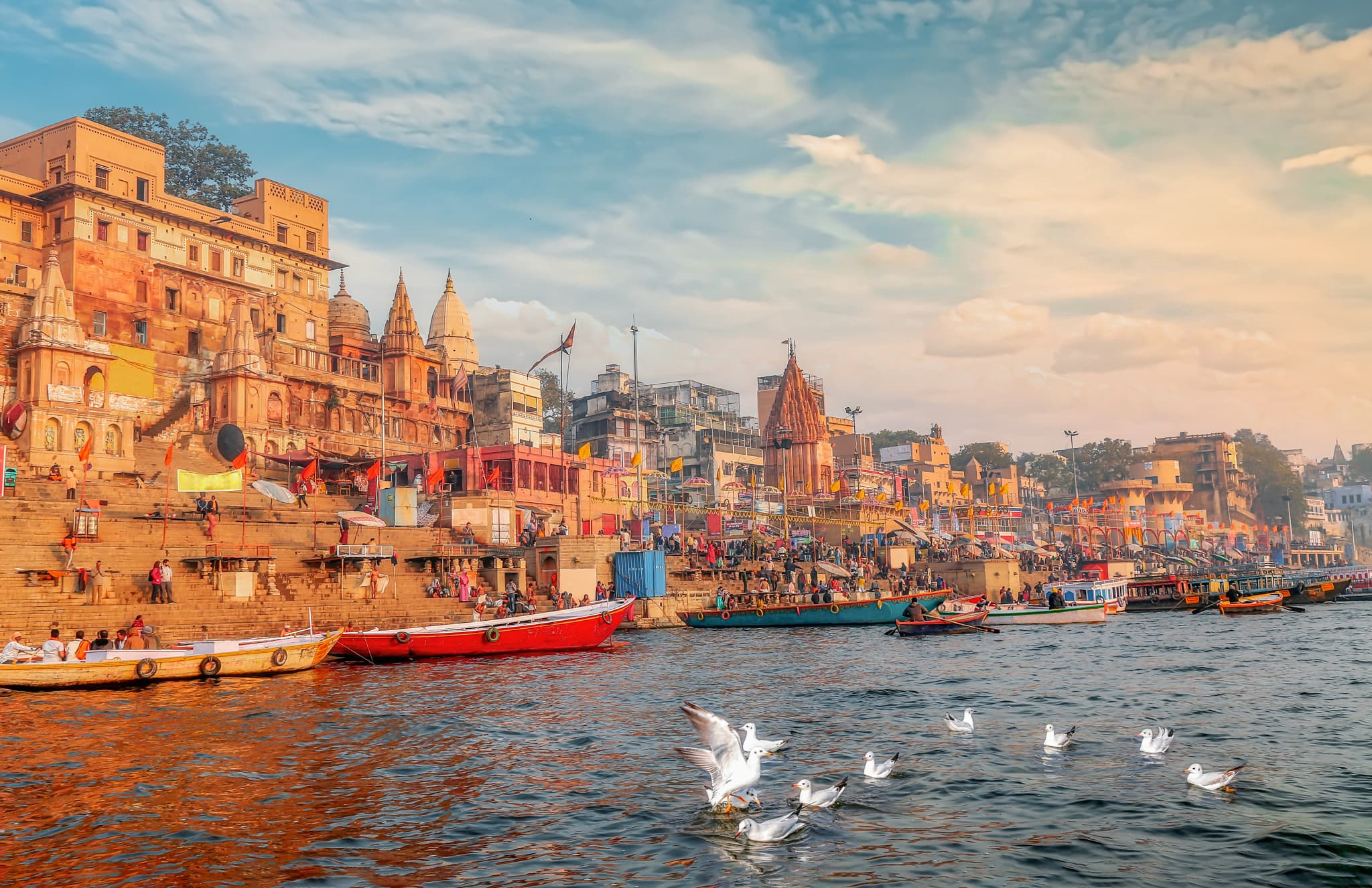 Varanasi Ganges river ghat with view of migratory birds on river Ganga at sunset