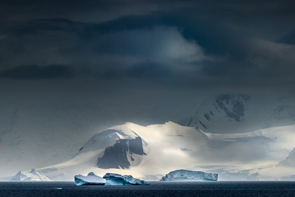antarctica icebergs dark sky 1024x684