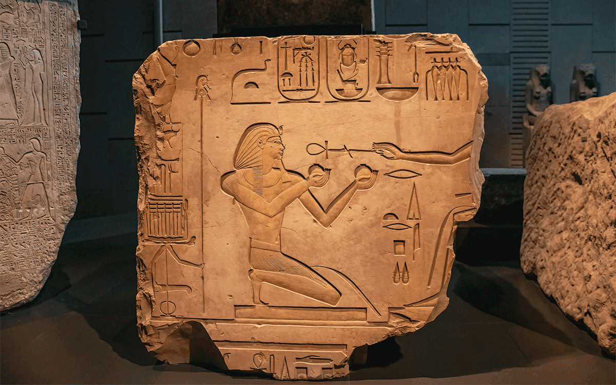 Ancient Egyptian carvings and hieroglyphs on sand stones at the Grand Egyptian Museum in Cairo, Egyp