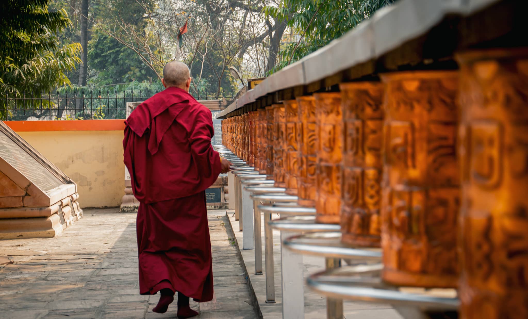 A monk with prayer wheels in a Bhuddisht temple