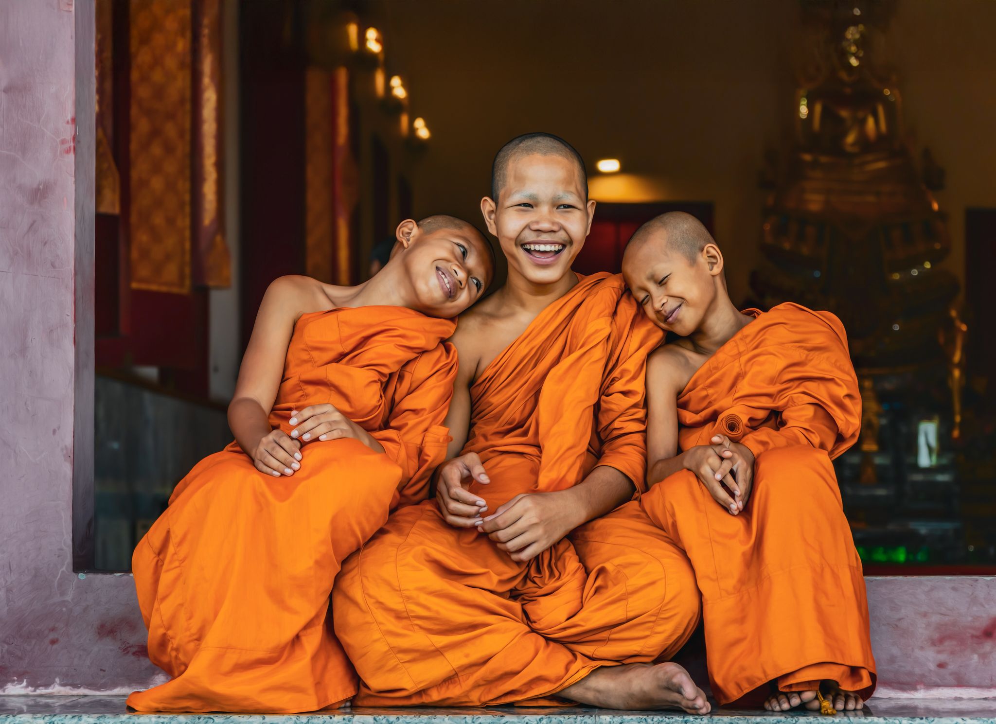 Three monks laughing together