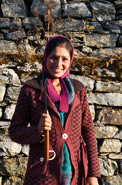 india himalayas trek local villager woman scythe