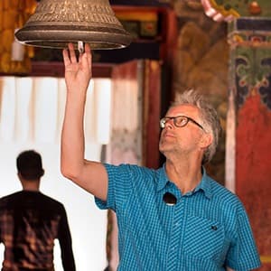 tibet geoex trek leader bart jordans ringing bell