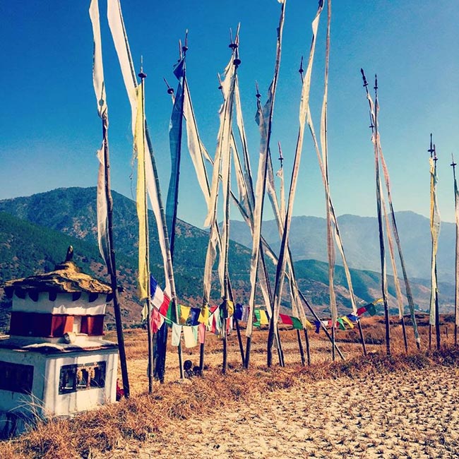 Prayer flags and chorten in a Bhutan valley