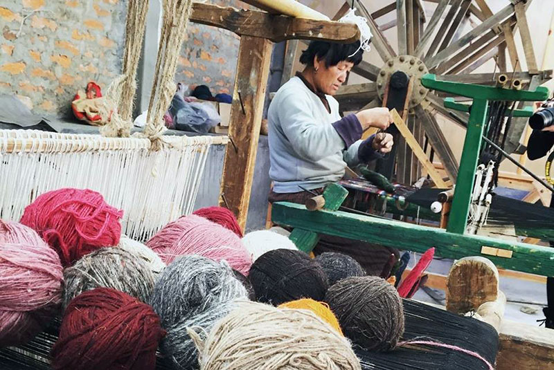 A weaver creating Bhutanese textiles in Bhutan