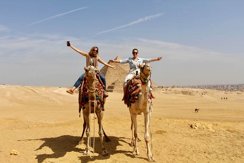 GeoEx travel expert, Kim Keating, on camel back in Giza, Egypt