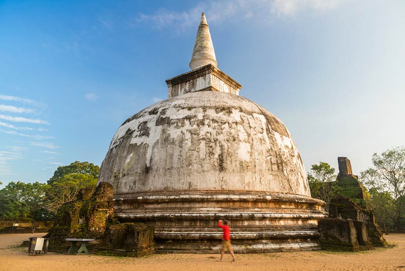 Man walking around Stupa ancient city of Polonnaruwa, UNESCO World Heritage Site, North Central Province, Sri Lanka