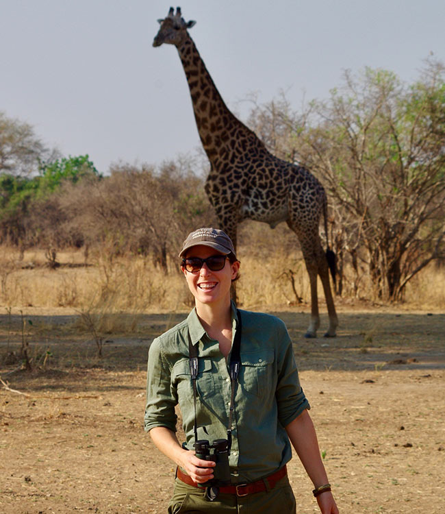 GeoEx specialist Jess Silber with a giraffe during a Zambia walking safari,