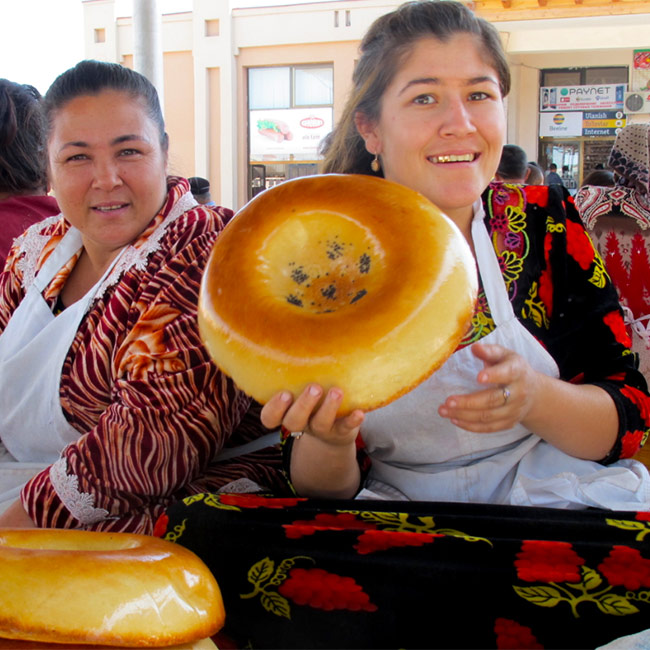 Uzbek ladies selling traditional bread at the market in Samarkand, Central Asia