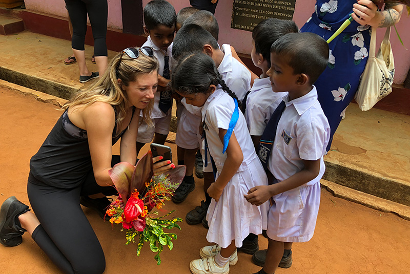 GeoEx staffer Kim Keating in Sri Lanka showing kids selfie