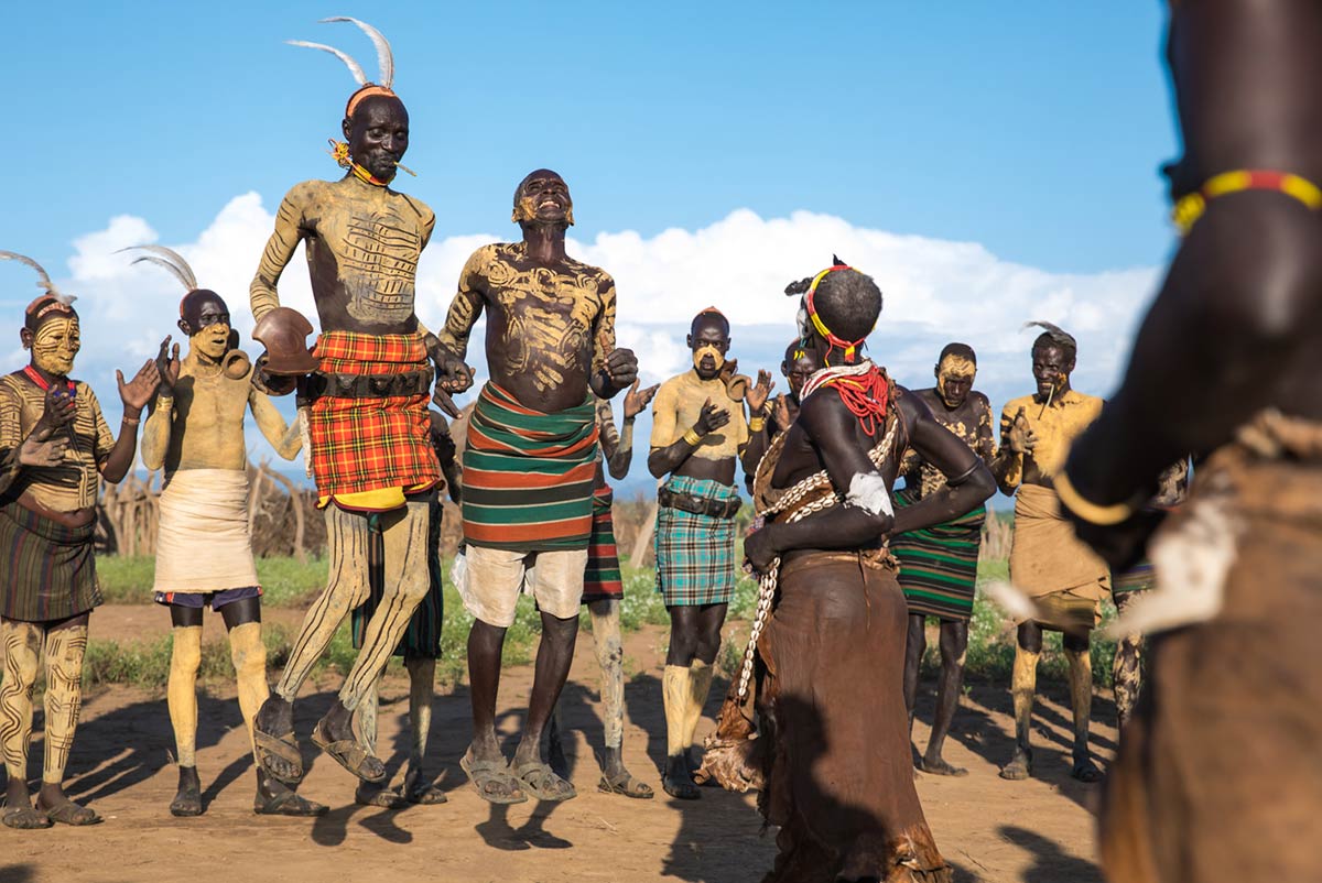 Kara tribe dancing in the afternoon sun, Omo Valley, Ethiopia