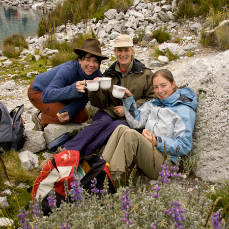 Hikers drink tea at Lake 69 in the Cordillera Blanca range of the Andes Mountains, Peru with GeoEx.
