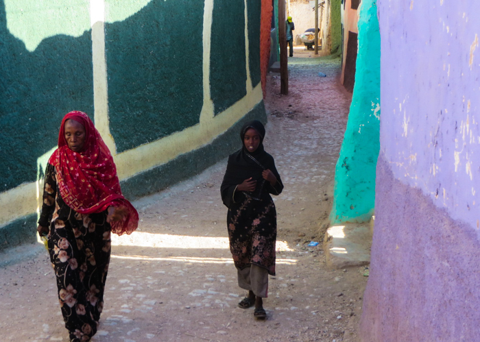 Meeting women walking down the street of old town, Harar, Ethiopia with GeoEx.