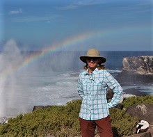 GeoEx Staffer Amanda McKee in front of blowhole in the Galapagos Islands | GeoEx Adventure Travel