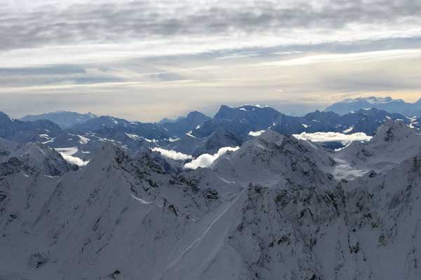 Aerial view of snow-capped mountains in Alaska with GeoEx.