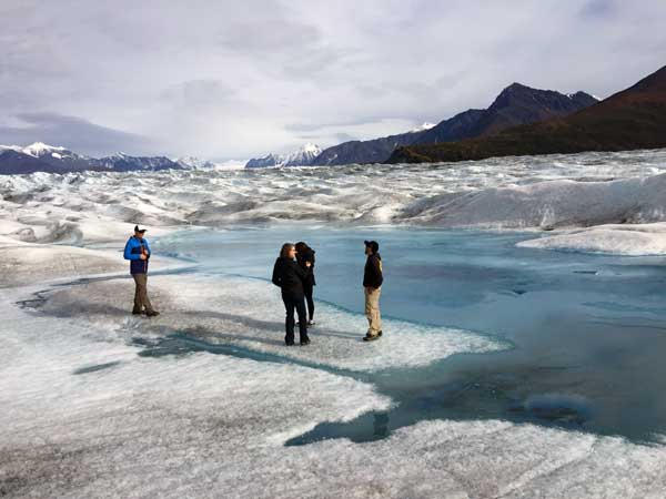 Standing on a glacier in Alaska with GeoEx.
