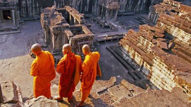 Three monks overlook Angkor Wat, Cambodia with GeoEx