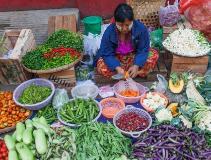 Vegetable seller at a street market in Yangon, Myanmar with GeoEx