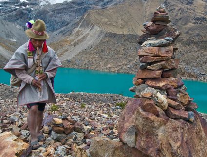 Peruvian man in front of glacial lake in Sacred Valley, Peru