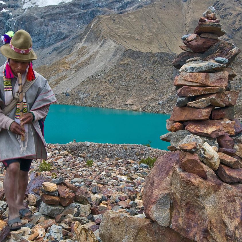 Peruvian man in front of glacial lake in Sacred Valley, Peru