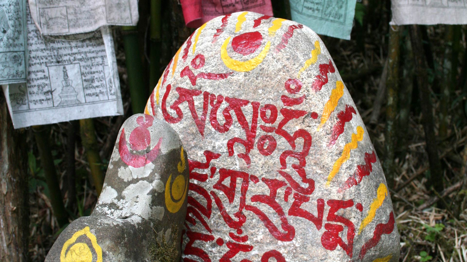 Prayer flags and stones along the trail to Repuzham