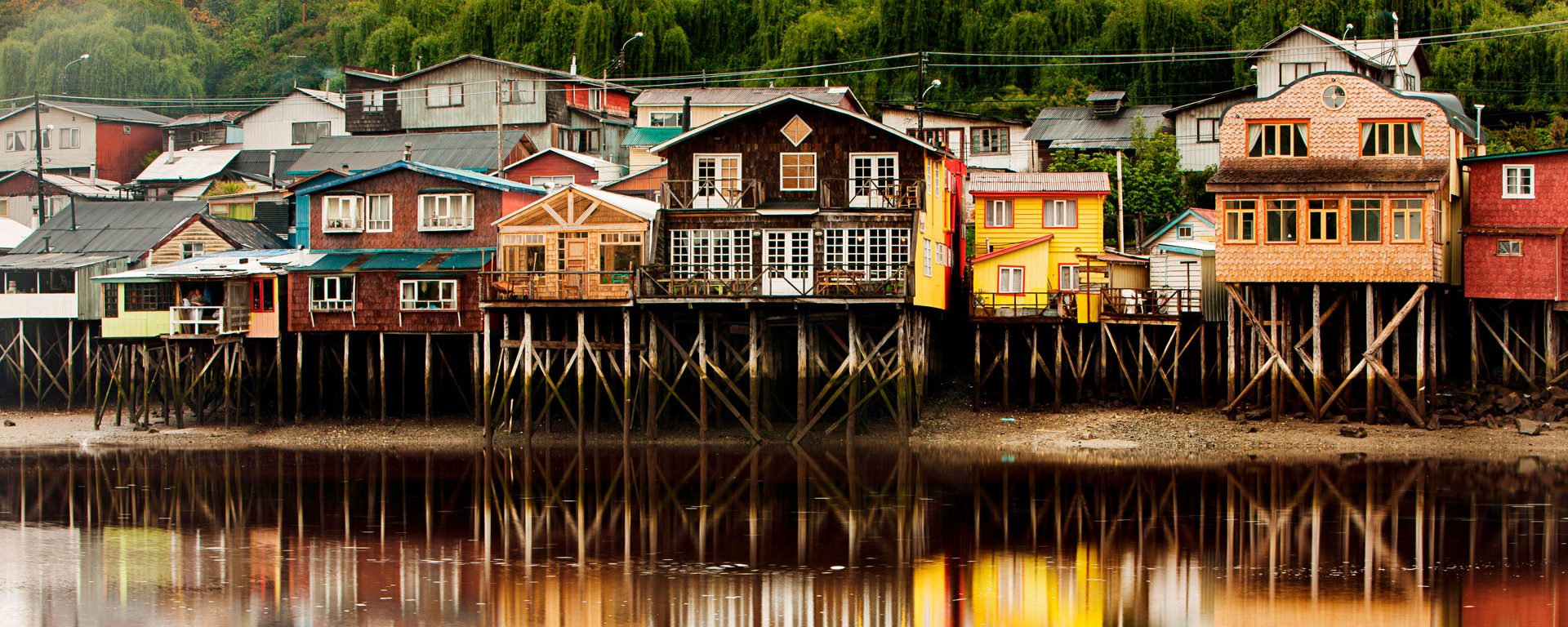 Palafito stilt houses in the tidal bay at Chiloe, Patagonia, Chile