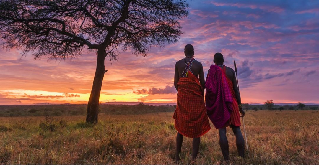 Two Maasai tribesman at dawn in the Masai Mara, Kenya