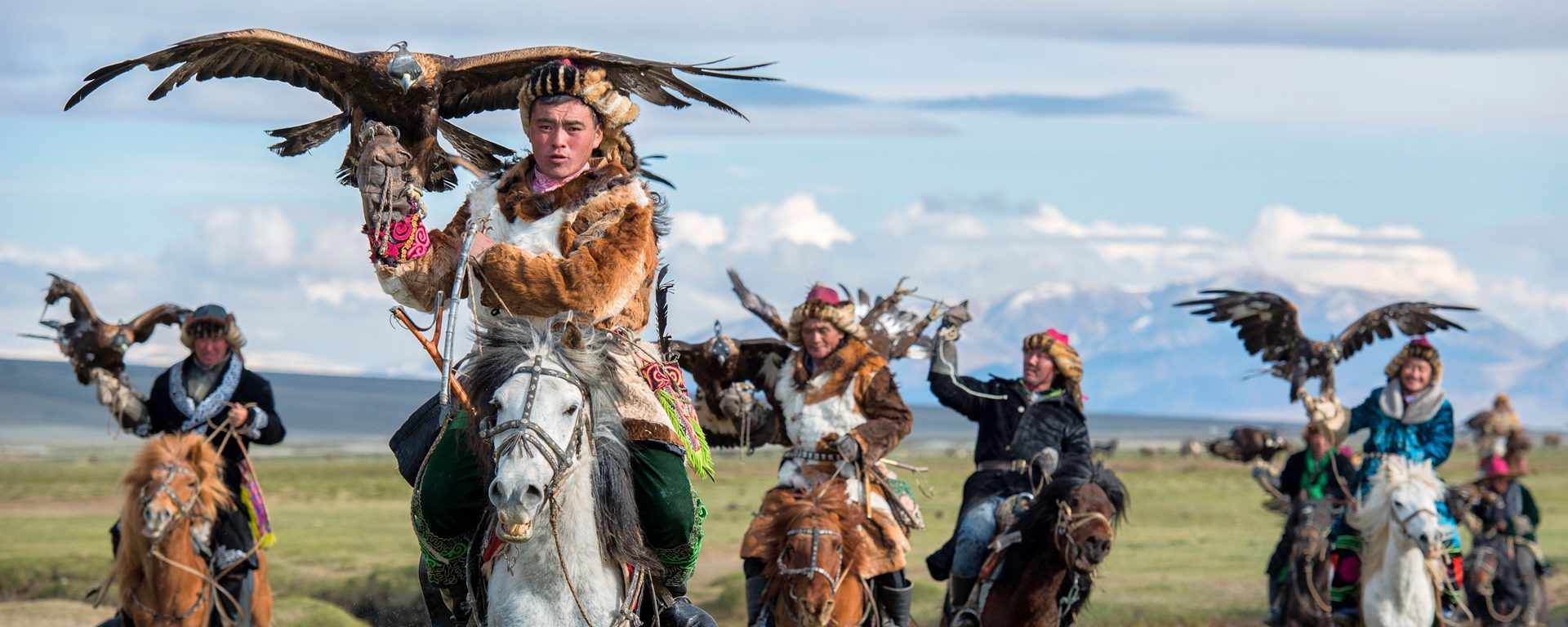 Kazakh eagle hunters on horseback in the the Altai mountains, Mongolia