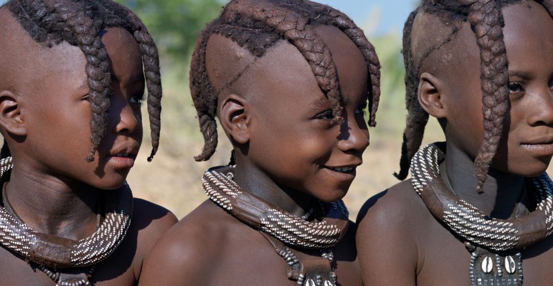 Three young Himba girls wearing necklaces, Namibia