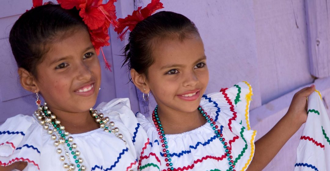Girls in traditional dress after dance in Villa Esperanza barrio, Granada, Nicaragua