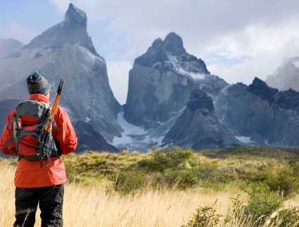 A hiker in front of the iconic Cuernos del Paine, Patagonia