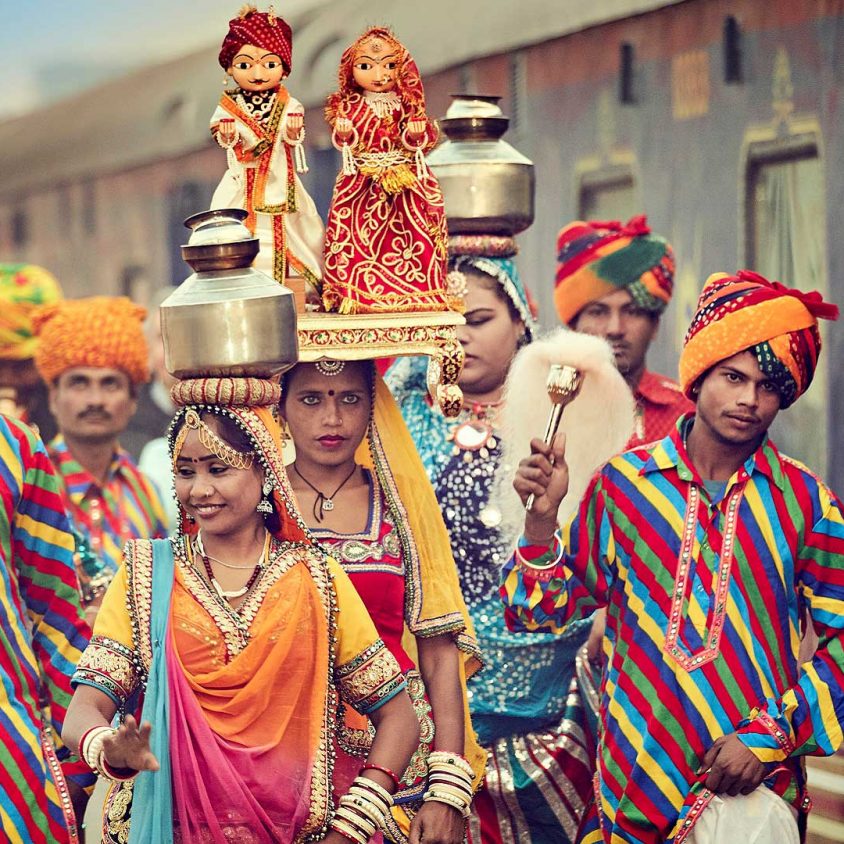 Colorfully dressed locals welcome the Deccan Odyssey train in Jaipur, India with GeoEx
