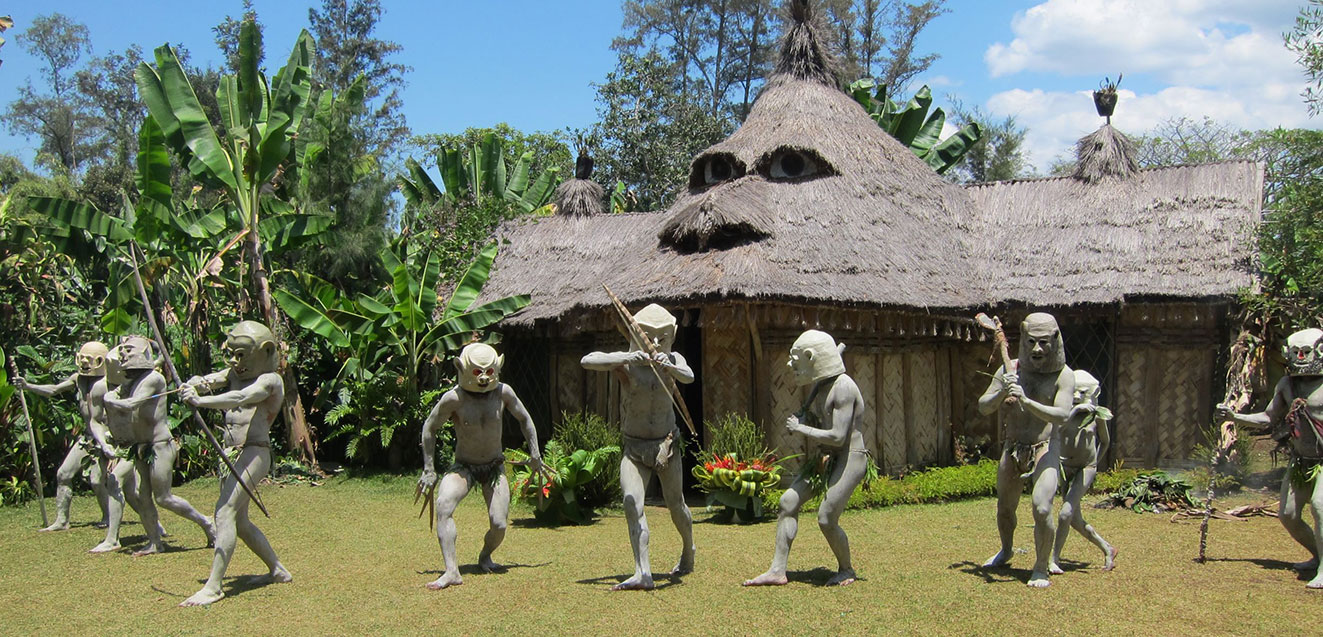 Asaro Mud Men wearing masks posing with weapons