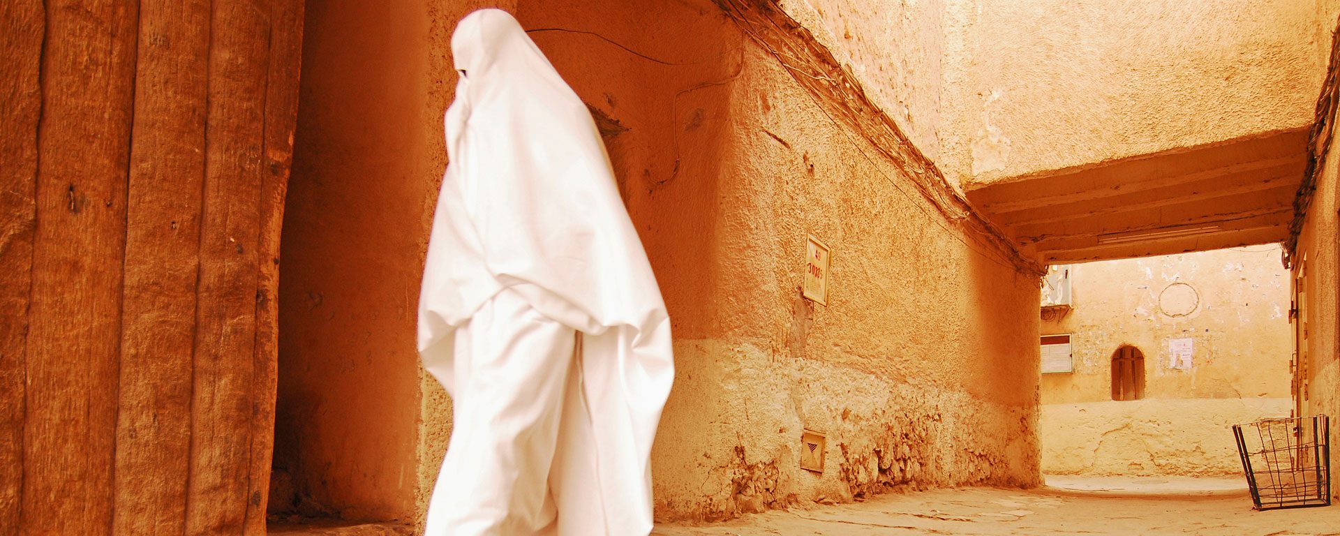 Woman walking through narrow streets of Ghardaia, Algeria