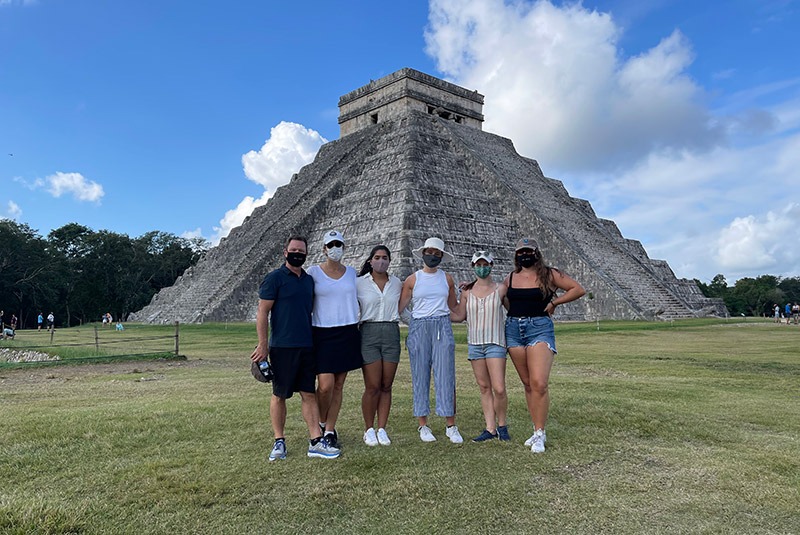 Family in front of El Castillo pyramid in Chichen Itza, Mexico