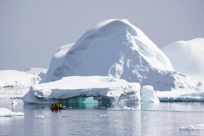 Zodiac motors past glaciers in Antarctica