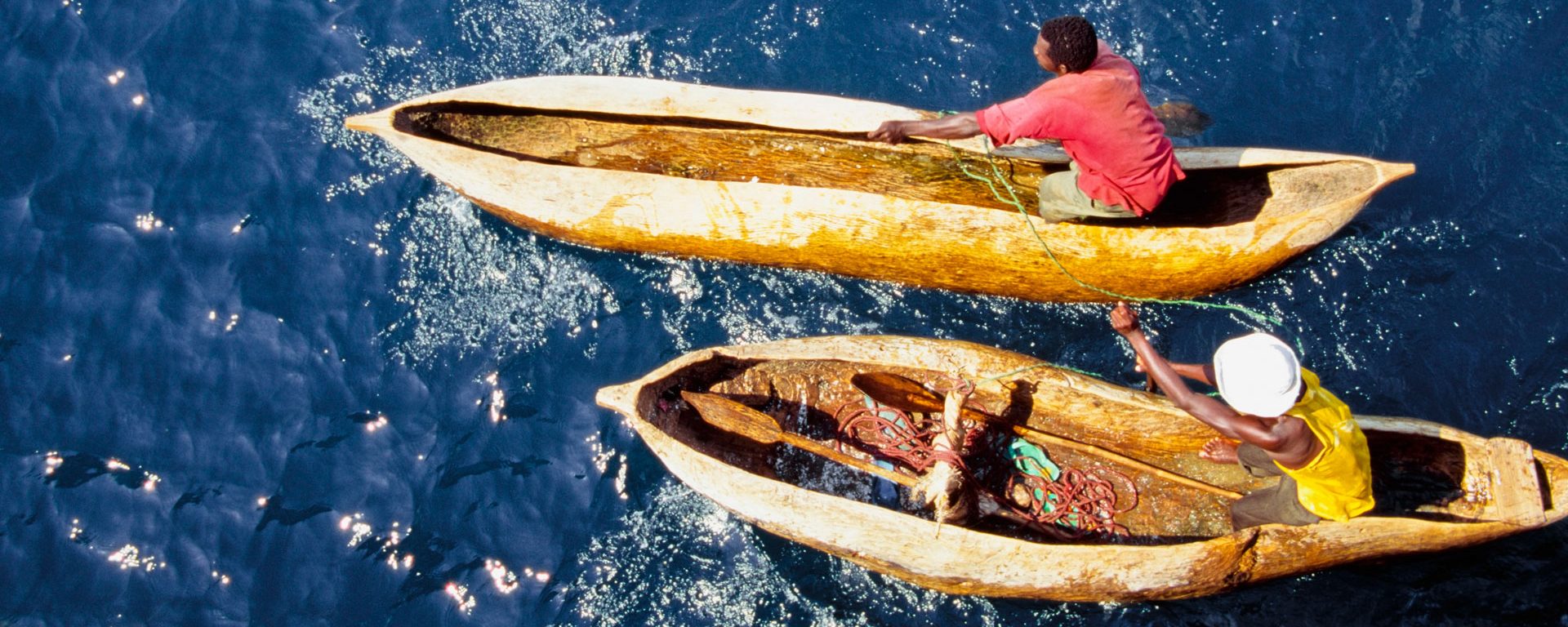 Men in dugout canoes on Laka Nyasa, Mozambique