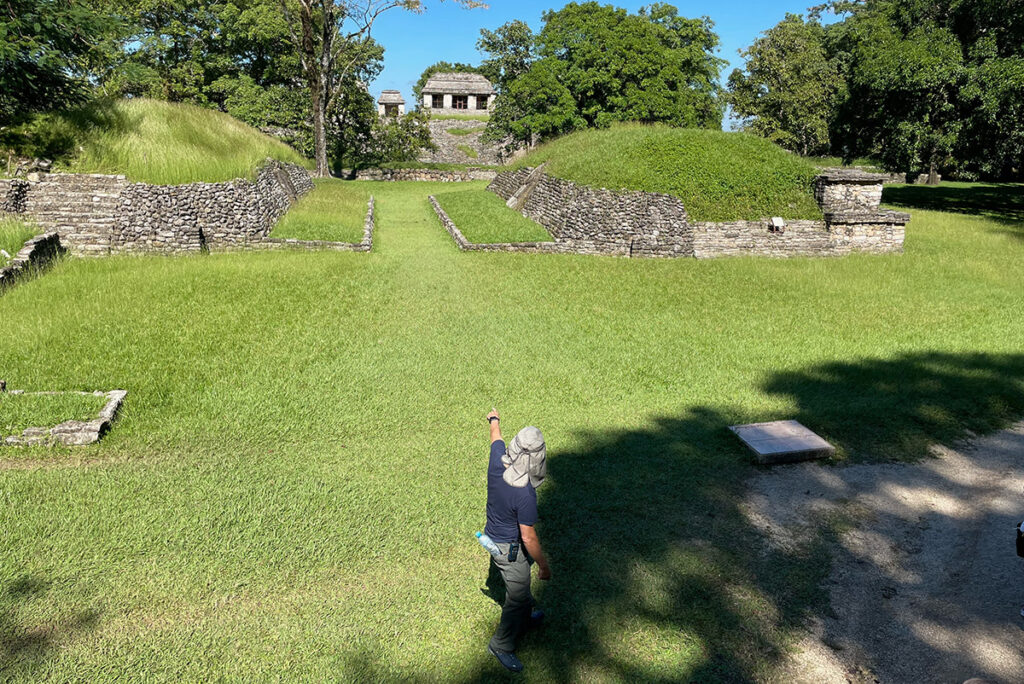 Guide showing the ball court at Palenque, Mexico