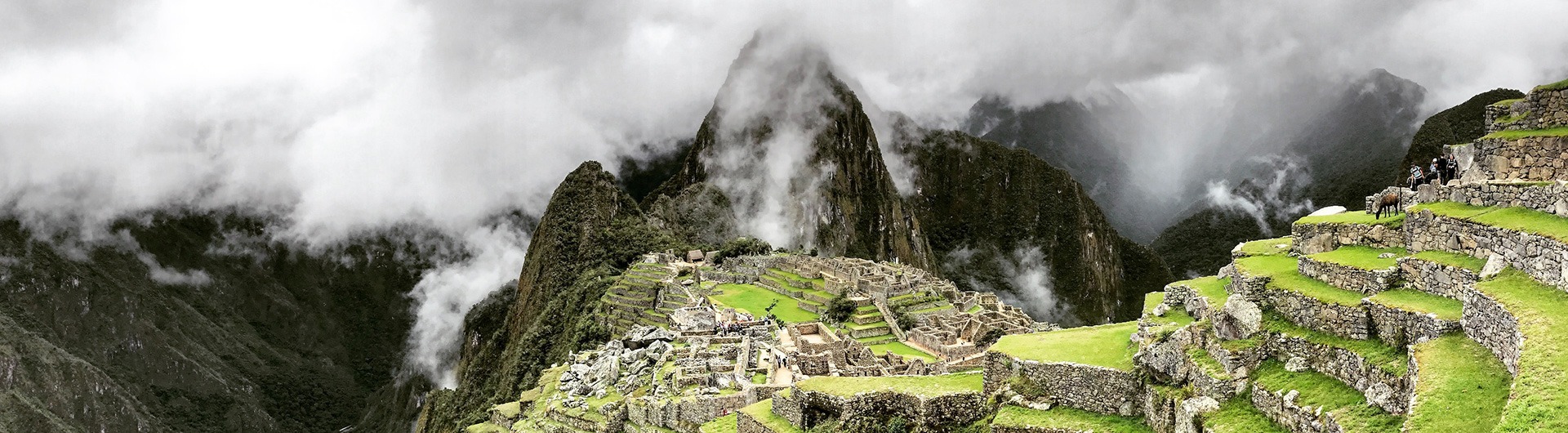 Machu Picchu partially shrouded in clouds, Peru