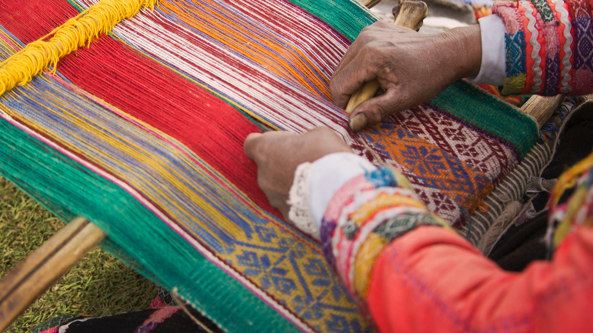 Weaver using a traditional backstrap loom near Cusco, Peru