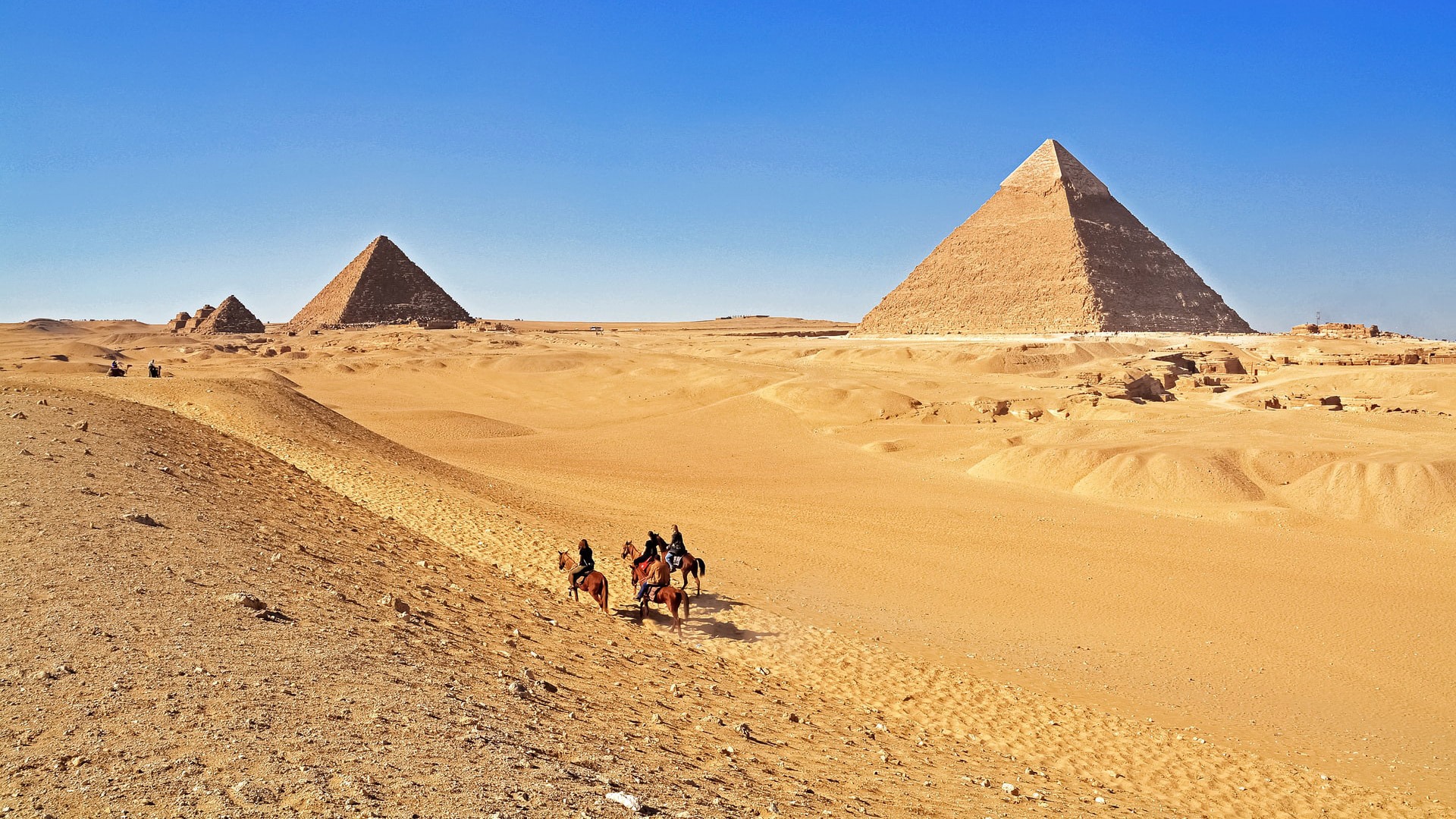 Riding horses near the Great Pyramids of Giza, Cairo, Egypt